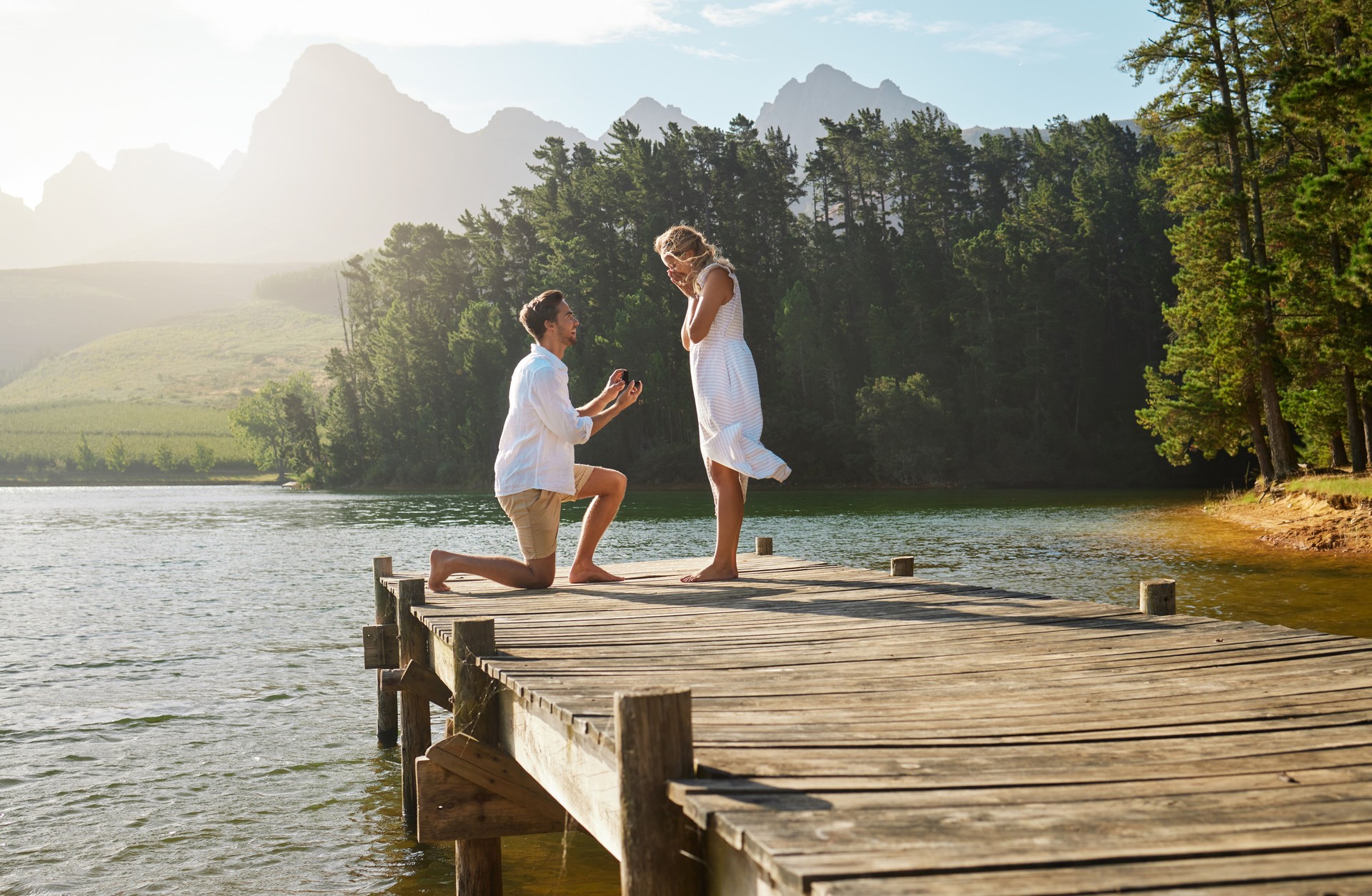 Shot of a young man proposing to his girlfriend in nature